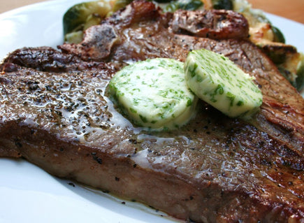 Pepper Rubbed Porterhouse Steaks with Chive Butter