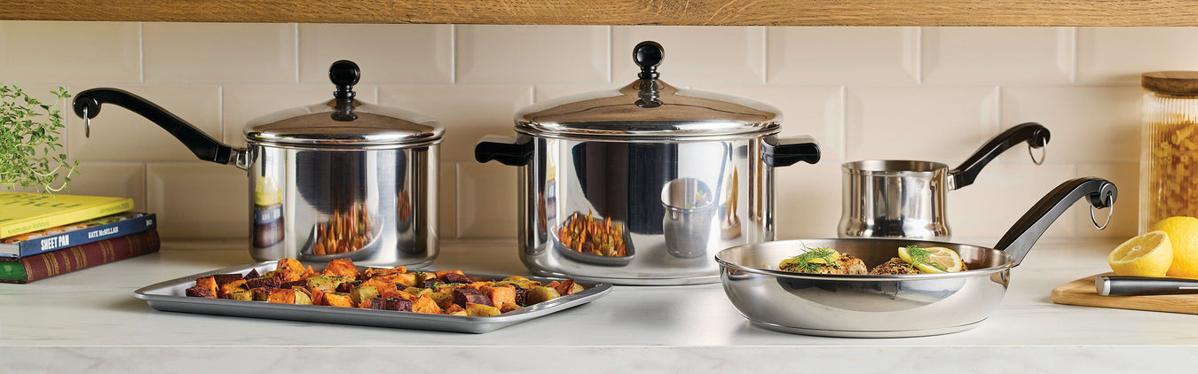 A stainless steel pot filled with soup, containing chicken and vegetables. Nearby are small bowls of chopped onions and avocado.