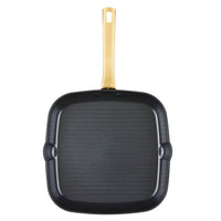 The Forged Induction Ceramic 11-Inch Square Grill Pan is a black square pan made from durable forged aluminum, boasting a long yellow handle. Its induction-compatible ceramic nonstick surface guarantees even cooking and simplifies the cleaning process.
