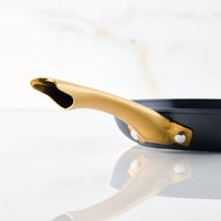 Forged Induction Ceramic 8.25-Inch Frying Pan with a golden handle, made from forged aluminum, featured on a sleek white background.