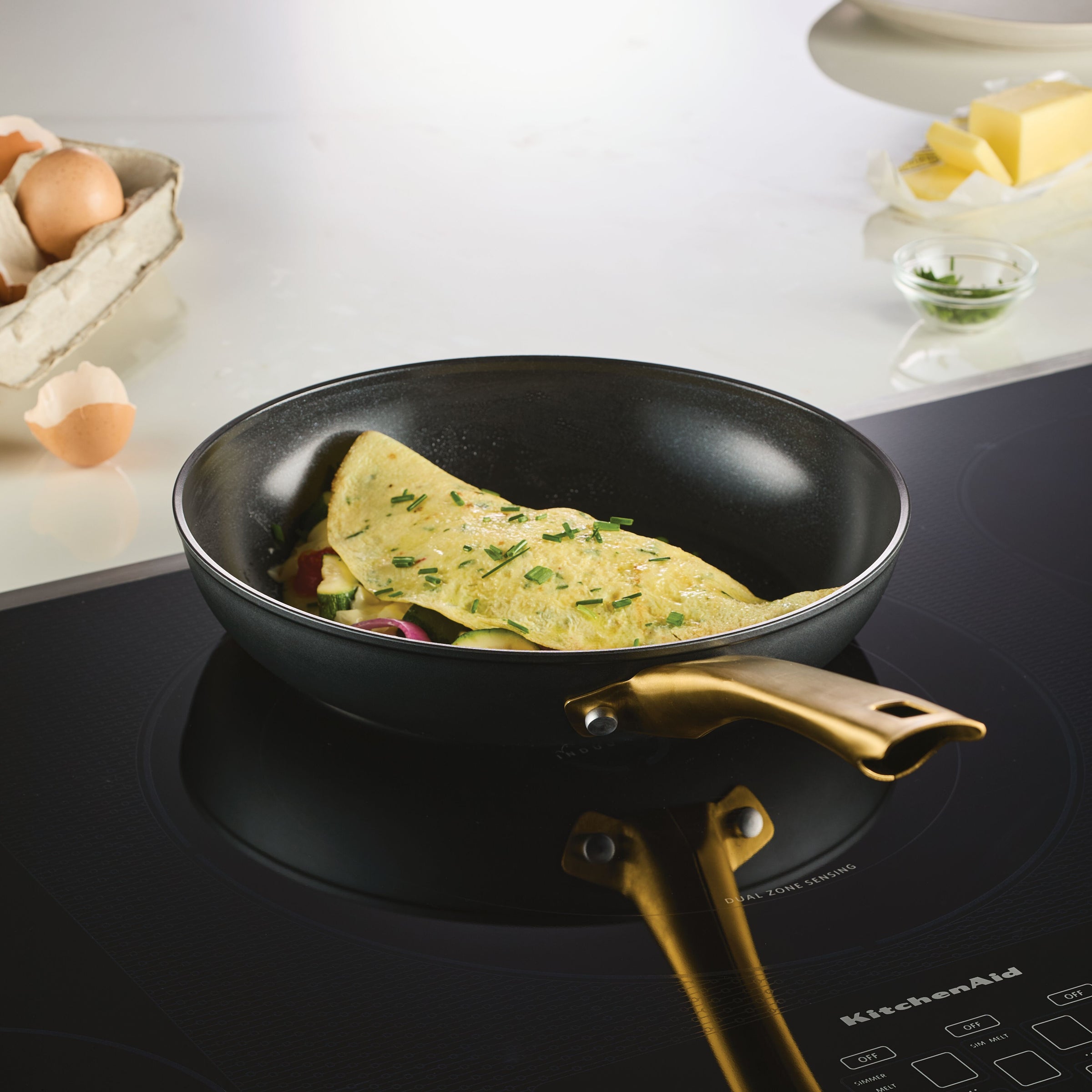 A Forged Induction Ceramic 10-Inch Frying Pan allows an omelet to sizzle perfectly, ensuring even heat distribution on the induction stove.