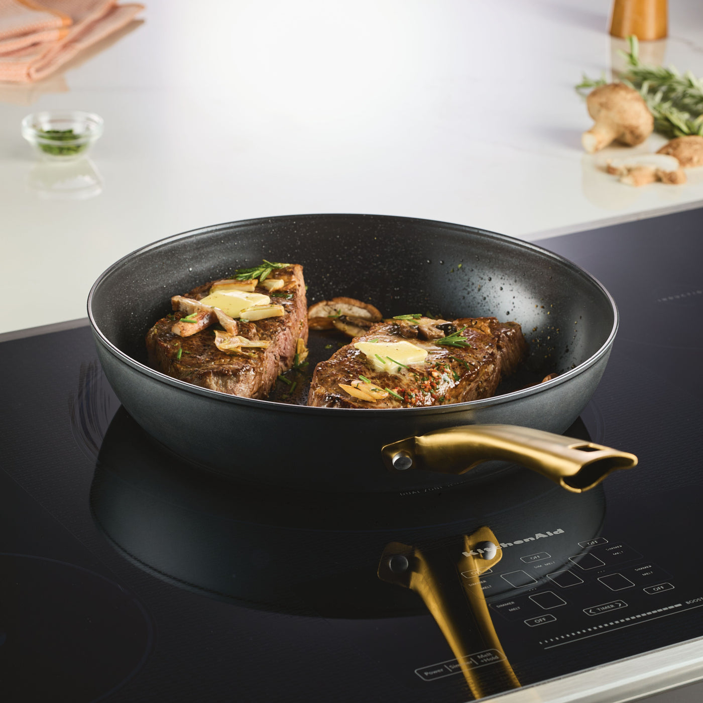 Steaks simmering in a skillet from a 6 Piece Cookware Set, topped with herbs.