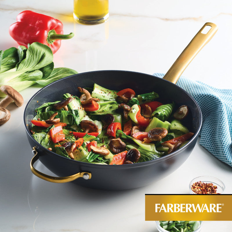 Stir-fry vegetables in the 12.25-Inch Stir-Fry Pan with Helper Handle on the counter.