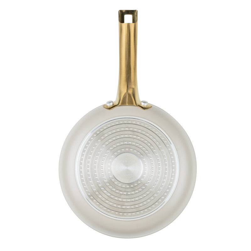 A bottom view of the Forged Induction 8.25-Inch Frying Pan's exterior base. The silver, induction-compatible plate features a textured pattern of concentric dots for efficient heat conduction. The pan’s taupe exterior and the underside of the gold-tone handle, including its double-rivet attachment, are clearly visible.