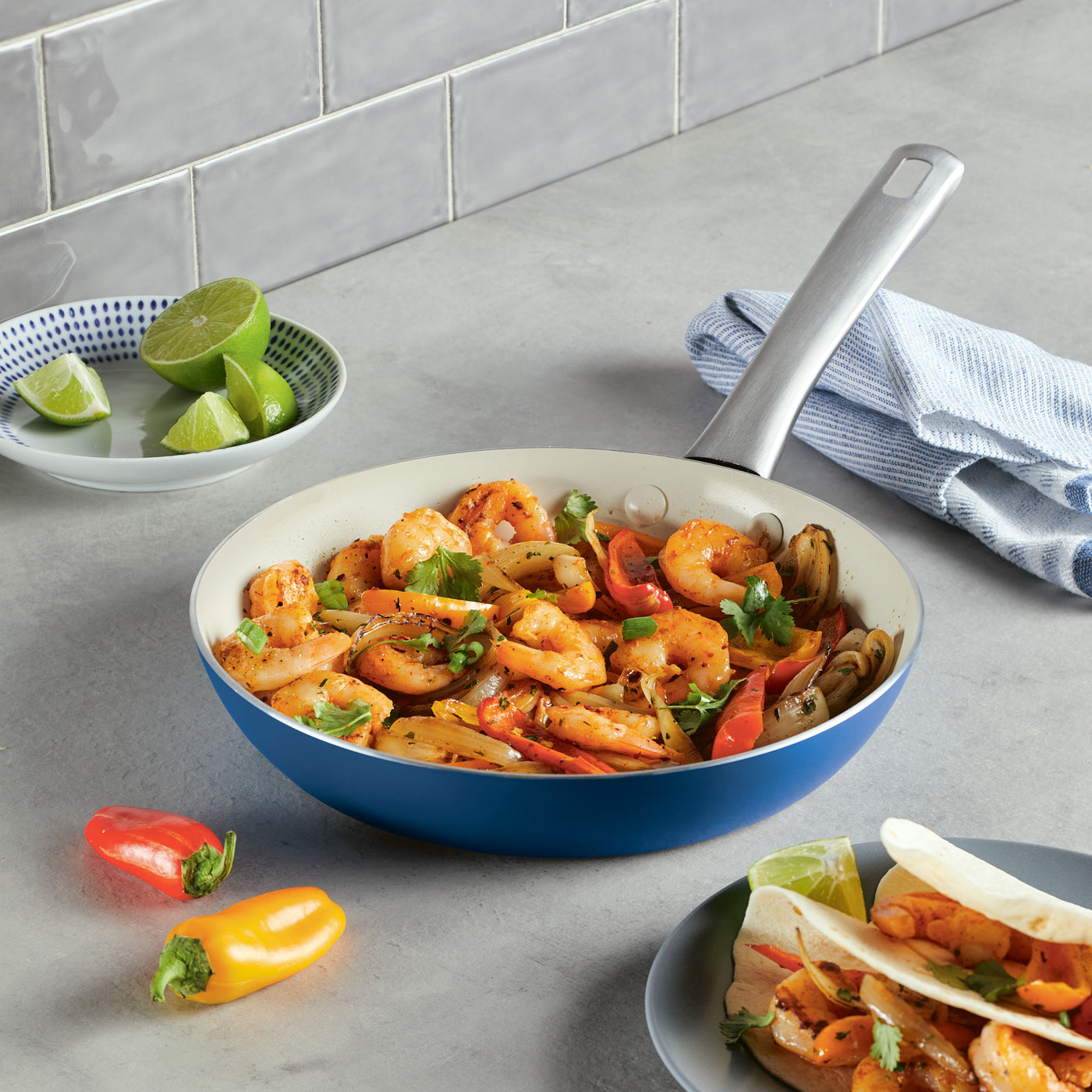 Shrimp and vegetables sautéed in a 10 Inch Ceramic Nonstick Frying Pan on a kitchen counter, highlighting the elegant design of this durable cookware.