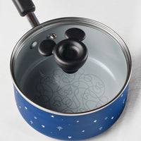 Blue saucepan with mouse-shaped lid handle and decorative interior pattern.