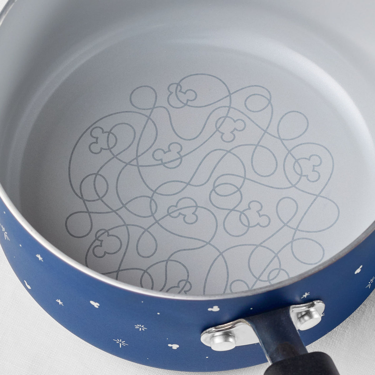 Blue saucepan interior with a Mickey Mouse maze design.