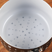 Inside a 2-Quart Monochrome Ceramic Nonstick Saucepan with Lid from the Farberware cookware line, small, patterned mouse head designs adorn the bottom.