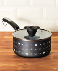 As part of the Monochrome Collection, the 2-Quart Ceramic Nonstick Saucepan with a glass lid features whimsical Mickey Mouse designs in black, creating a charming addition to your Farberware cookware set.
