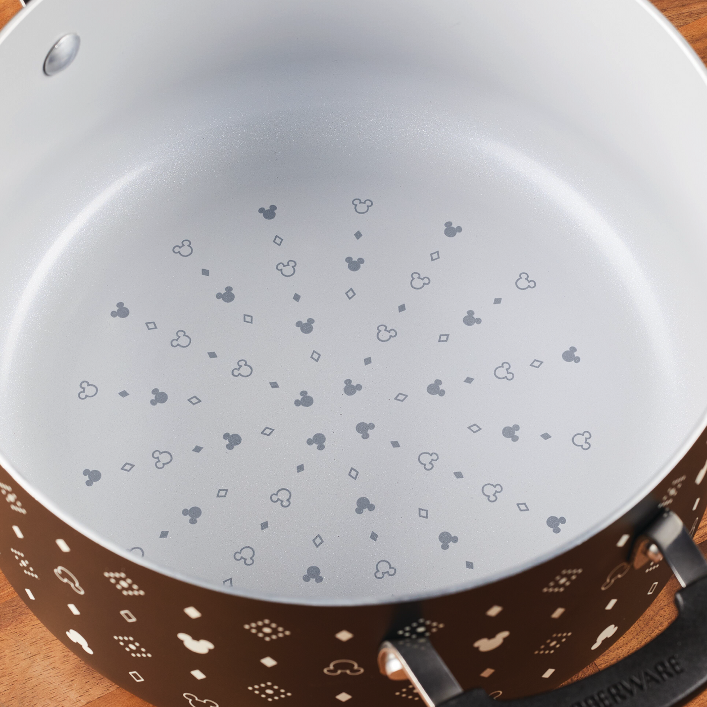 Within the 5.5-Quart Monochrome Ceramic Nonstick Stockpot with Lid, you'll discover a whimsical surprise at the bottom that echoes the charm of Disney magic.