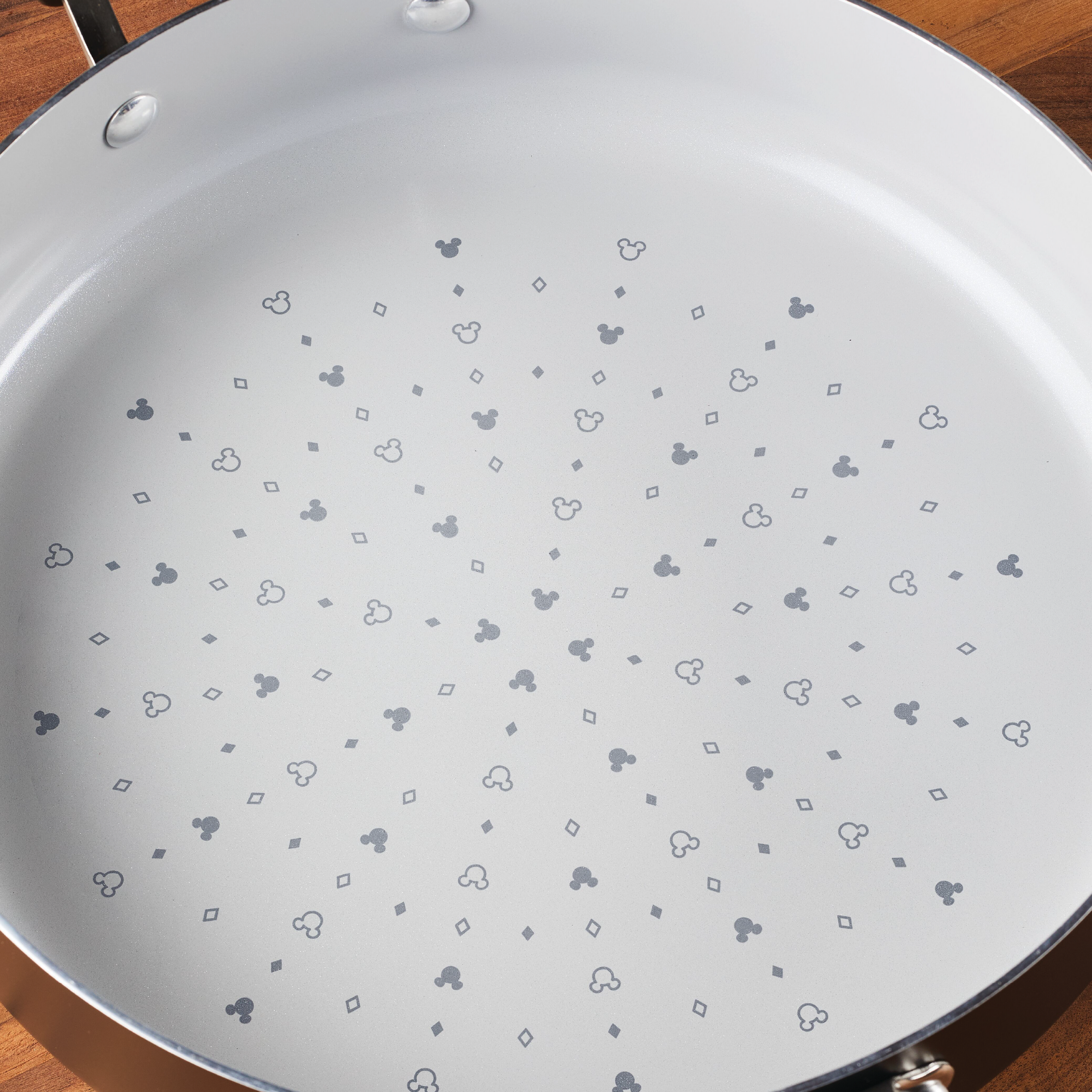 Check out the 4.5-Quart Monochrome Ceramic Nonstick Sauté Pan with lid and Helper Handle from our latest collection. Its stylish pattern of small clubs, diamonds, hearts, and spades brings a sophisticated flair to your kitchen while offering perfect even cooking every time.