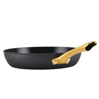 The Forged Induction Ceramic 12.25-Inch Frying Pan boasts a durable steel base and a golden handle, making it suitable for induction cooking.