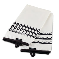 Add a touch of Disney Home Monochrome style with these kitchen towels, featuring two white pieces with black geometric patterns and tags.