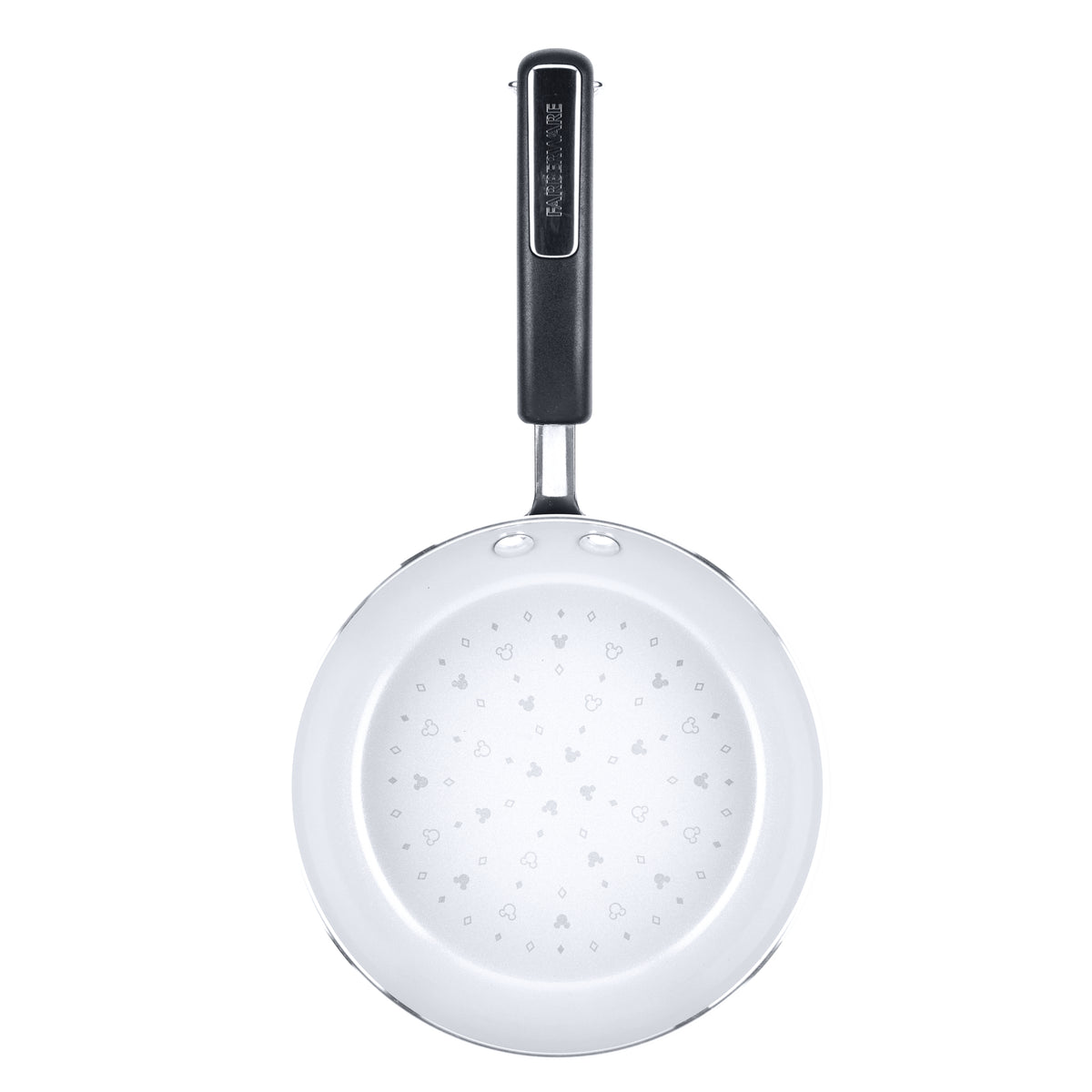 White frying pan with a black handle and heart patterns inside.