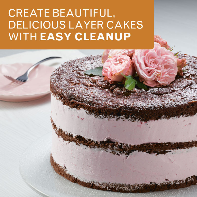 Create beautiful, delicious layer cakes with easy cleanup: chocolate layer cake with pink cream filling, topped with pink roses, on a cake stand