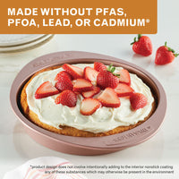 Made without PFAS, PFOA, lead or cadmium: rose gold round cake pan of cake topped with cream and fresh strawberries