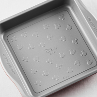 Square baking pan with Mickey Mouse patterns on the bottom surface.