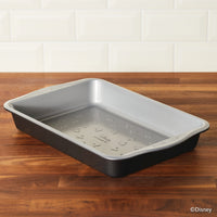 Rectangular baking pan with patterned interior on a wooden countertop.
