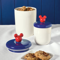 Part of the Bon Voyage collection, the Bon Voyage 2-Piece Ceramic Jar Set includes ceramic jars with vibrant red Mickey ear lids, ideal for storing your favorite cookies.