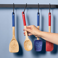 Display the Bon Voyage 2-Piece Spoon and Turner Set on a Disney Home wall rack featuring engraved designs.