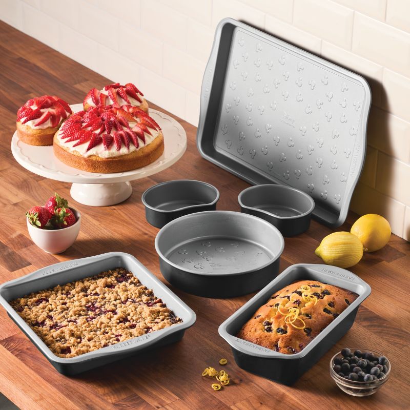 6-Piece Bakeware Set with assorted baked goods on a wooden kitchen counter.