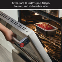 Someone puts a loaf pan from a 6-Piece Bakeware Set into an open oven.