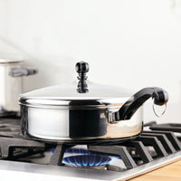 Classic Series 2.75-Qt Saute Pan with lid works on a gas stove burner.