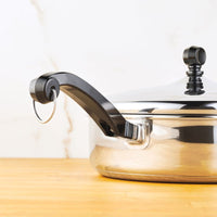 Classic Series 2.75-Quart Saute Pan with black handle and lid on wood surface.