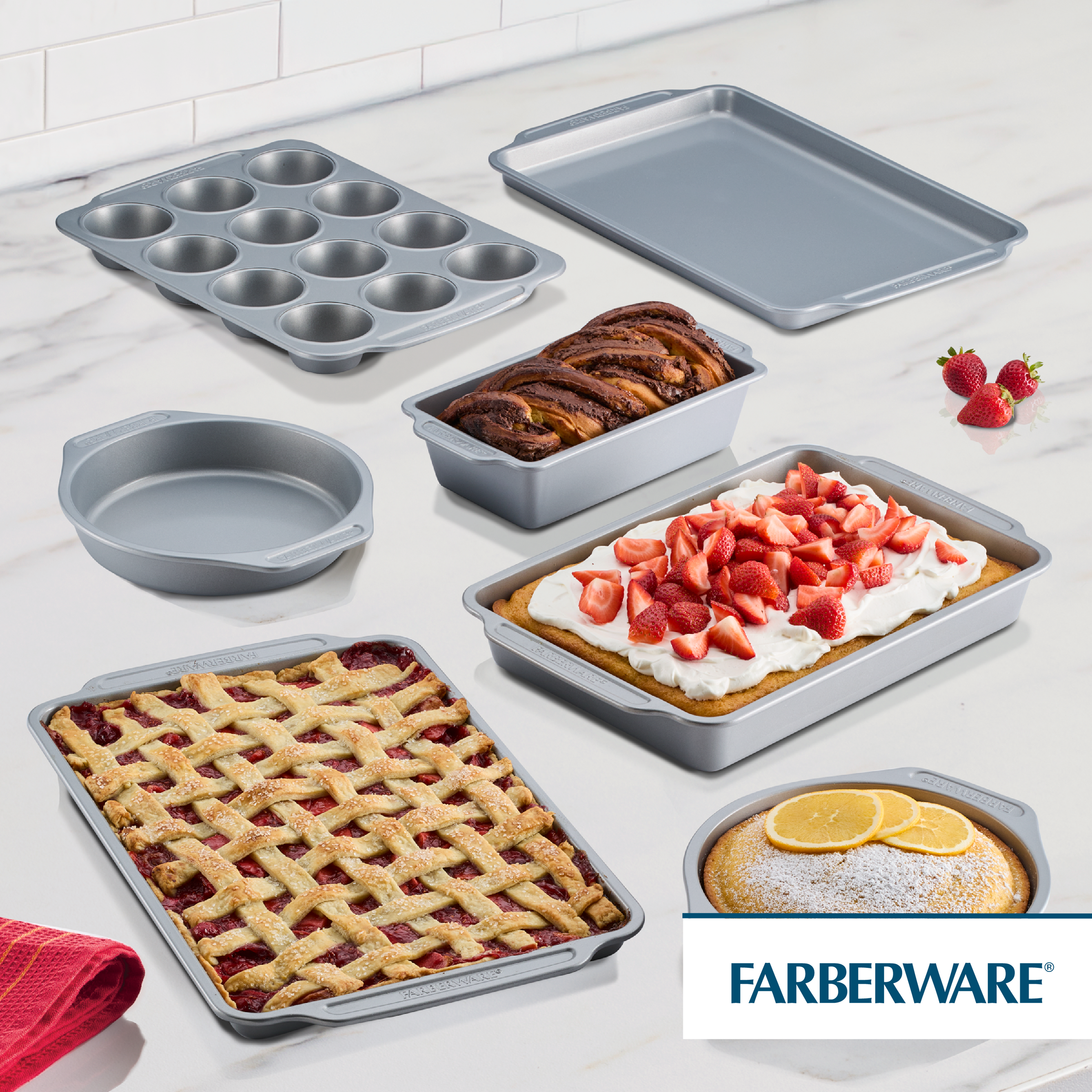 7-Piece Nonstick Bakeware Set with treats and strawberries on marble.