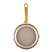 The Radiant Nonstick 2.75-Quart Sauté Pan With Lid, featuring a gold accent handle and renowned for its even heat distribution, is displayed against a white background.