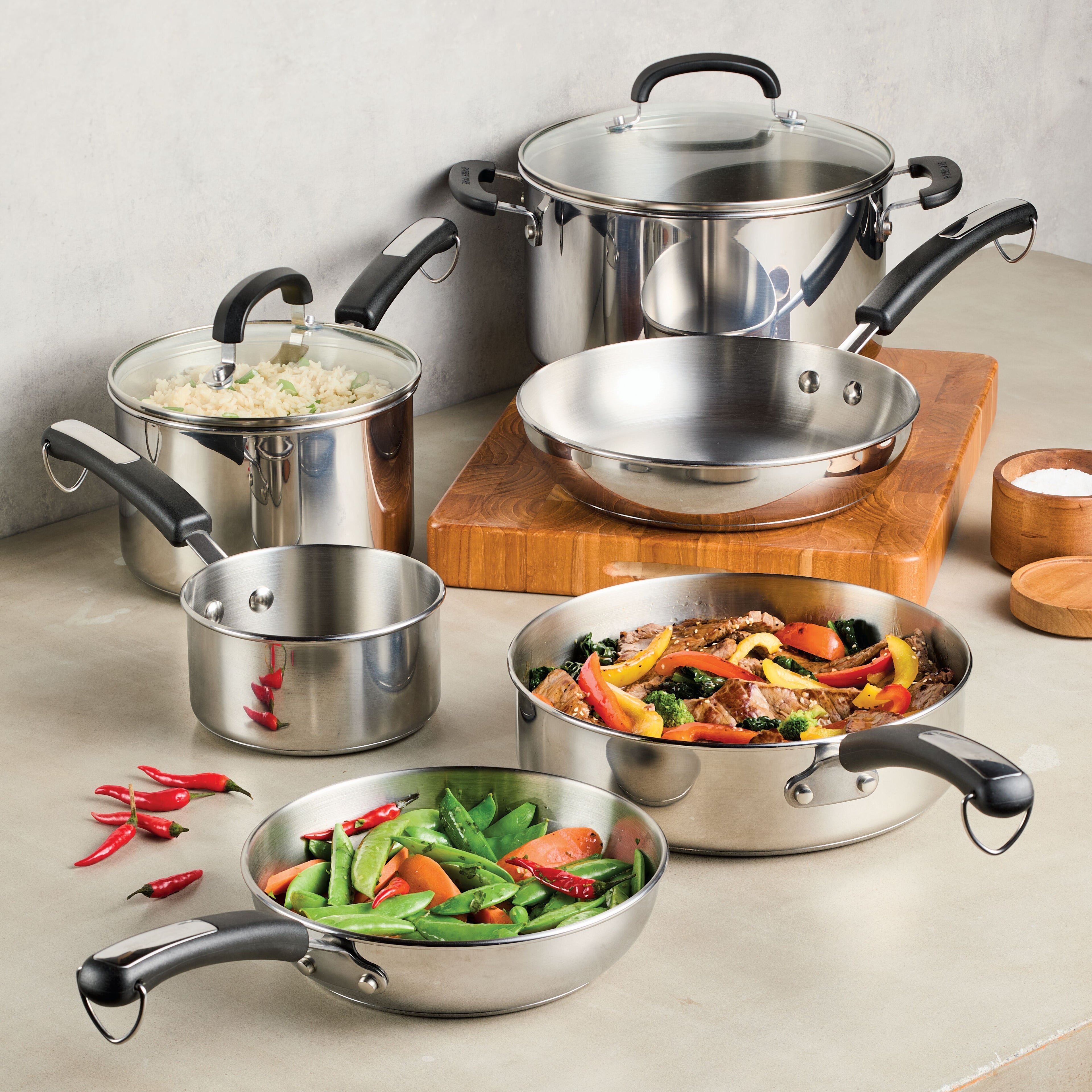The 10-Piece Stainless Steel Cookware Set from Farberware Brilliance beautifully presents delicious food on the kitchen counter.