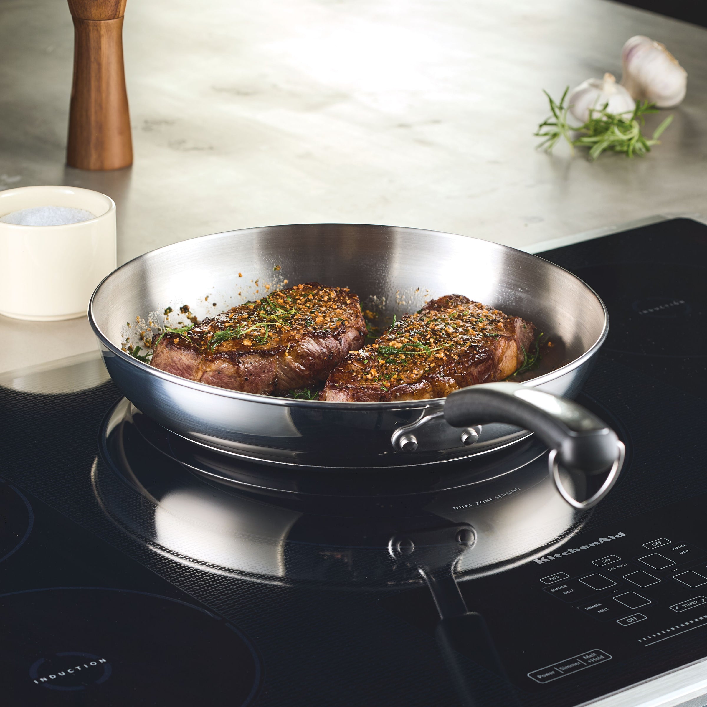 Enjoy perfectly cooked steaks on an induction stove with the 12.25-Inch Stainless Steel Frying Pan, ideal for everyday cooking.