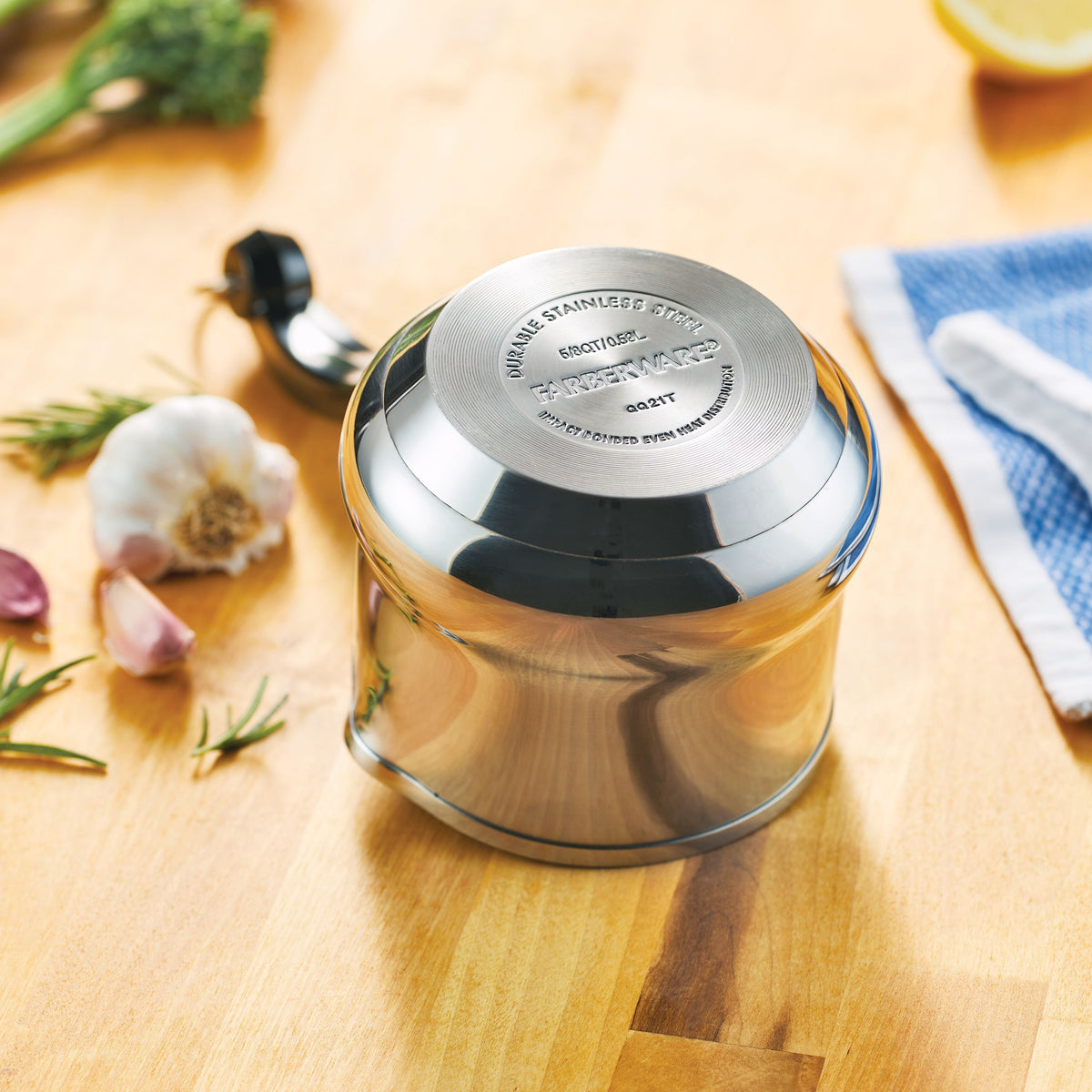 Stainless steel espresso maker with ingredients on a wooden surface.