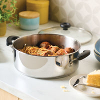 A 4-Quart Dutch Oven with Lid holds spaghetti and meatballs beside a cheese plate.