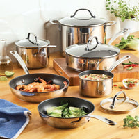The Millennium Nonstick Stainless Steel 10-Piece Set on a wooden kitchen counter.