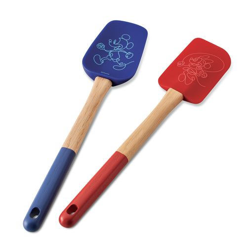 A delightful set of two wooden-handled utensils from the Bon Voyage 2-Piece Spatula and Spoonula Set, featuring one in blue and the other in red, both adorned with charming Disney Mickey Mouse designs.
