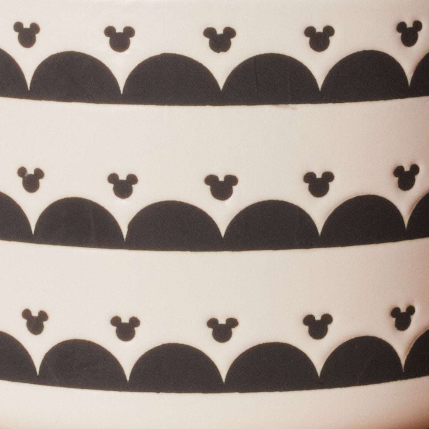 The Ceramic Jar with Airtight Lid showcases black patterns of Disney's Mickey Mouse on a clean white background, ensuring your contents stay fresh.