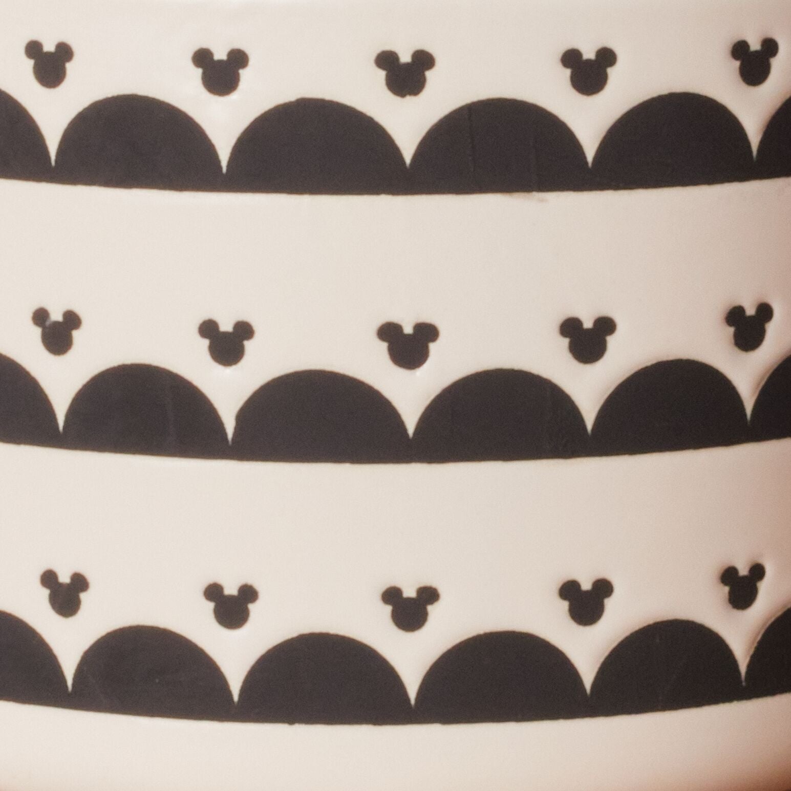The Ceramic Jar with Airtight Lid showcases black patterns of Disney's Mickey Mouse on a clean white background, ensuring your contents stay fresh.