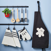 The 2-Piece Bamboo Salad Server Set from the Disney Home Monochrome collection hangs on a wall rack against a blue background.