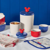 Explore the Disney Mickey Mouse Bon Voyage kitchen collection, highlighted by delightful ceramic jars from the Bon Voyage 2-Piece Ceramic Jar Set, elegantly arranged on a table. Ideal for fans embarking on a culinary adventure with their favorite classic character!