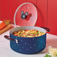 Pasta with vegetables in a decorative pot on a kitchen counter.