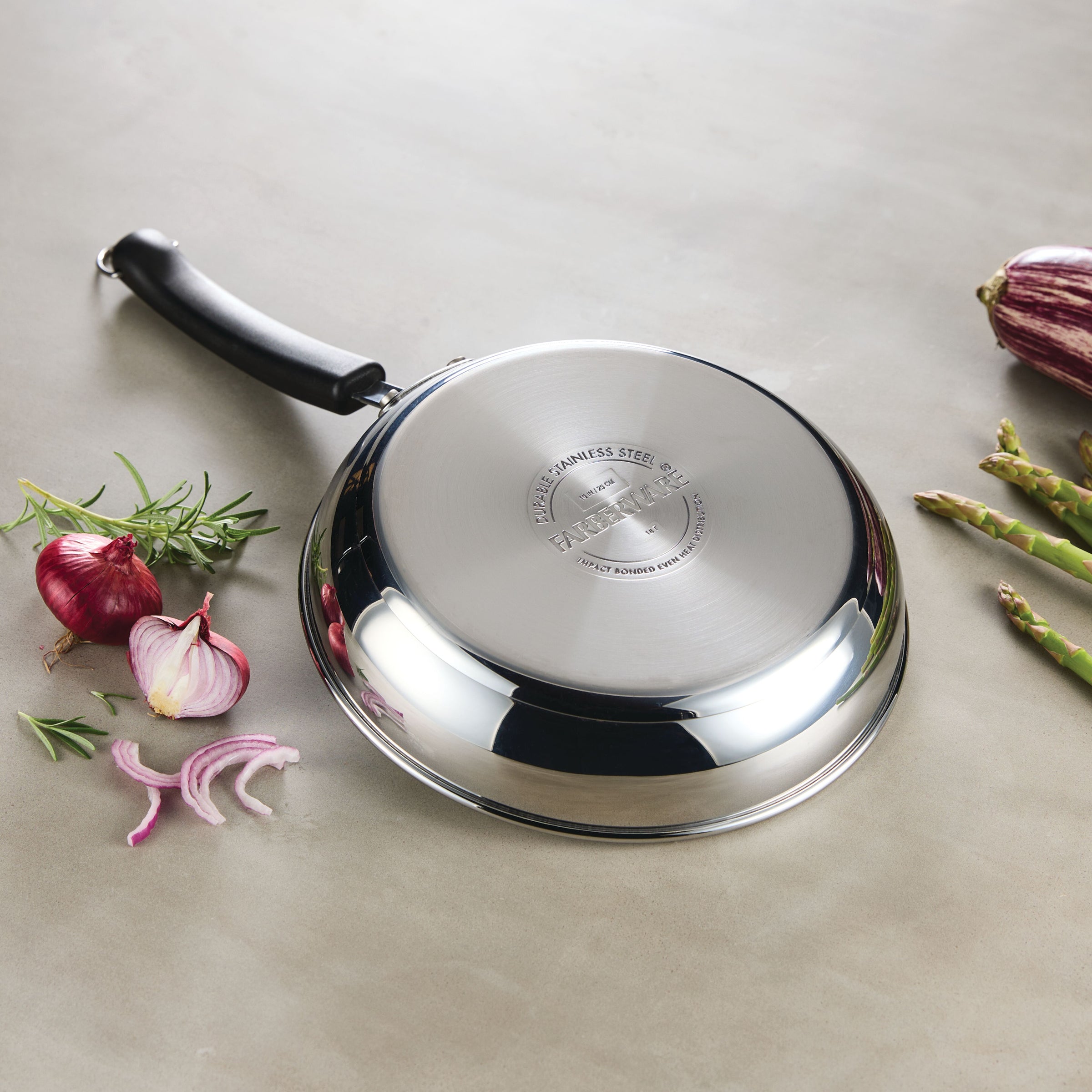 A pan from the 10-Piece Stainless Steel Cookware Set, featuring a stunning display of colorful vegetables, rests elegantly on the countertop, showcasing superior craftsmanship.