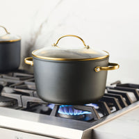 A pot on a gas stove with blue flame from the 6 Piece Cookware Set.