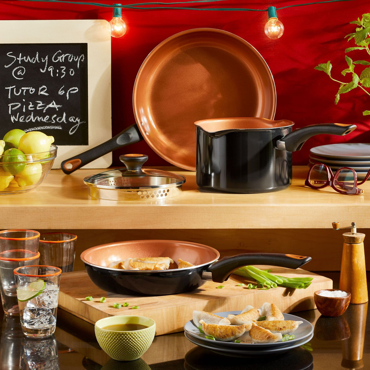 Scene featuring a Bundle of copper cookware, cutting board, and chalkboard notes in the kitchen.