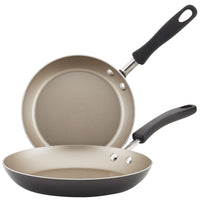 Two non-stick frying pans with black handles, stacked overlapping.
