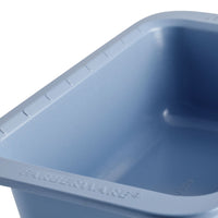 Close-up of a blue Farberware baking pan with visible ridged edges.