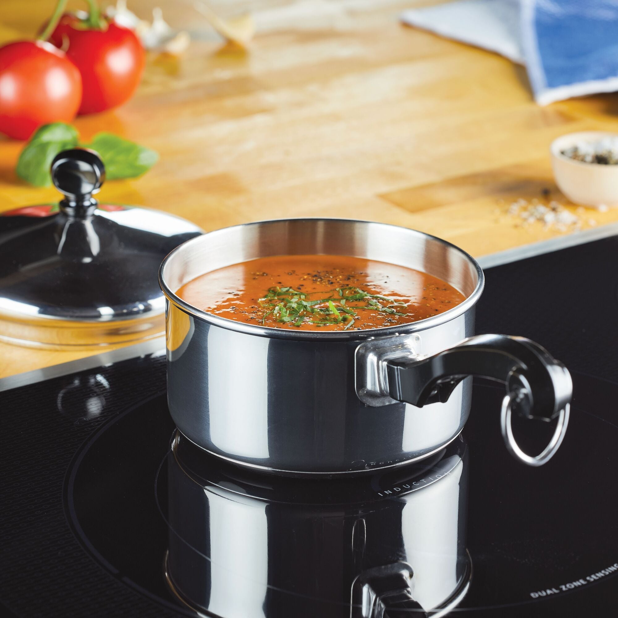 Soup simmering in the Classic Series Stainless Steel Saucepan on an electric stovetop, showcasing modern performance.