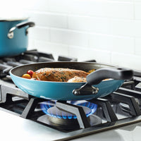 Blue frying pan with food on a stove burner.