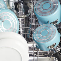 Blue pots and white dishes arranged inside a dishwasher.