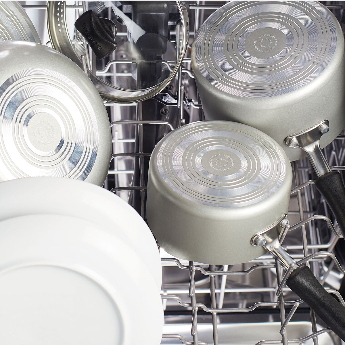 Pots and dishes arranged inside a dishwasher.